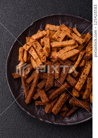 Crispy homemade brown bread crackers or croutons with seeds and grains 125428583