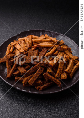 Crispy homemade brown bread crackers or croutons with seeds and grains Crispy homemade brown bread crackers or croutons with seeds and grains 125428584