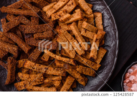 Crispy homemade brown bread crackers or croutons with seeds and grains 125428587