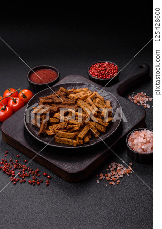 Crispy homemade brown bread crackers or croutons with seeds and grains Crispy homemade brown bread crackers or croutons with seeds and grains 125428600