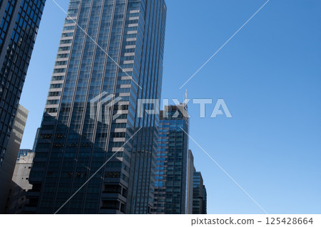Skyscrapers towering over the blue sky 125428664