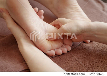 Woman receiving a foot massage 125428676