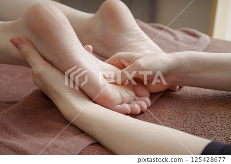 Woman receiving a foot massage 125428677