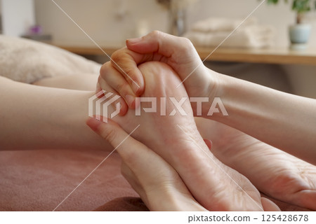 Woman receiving a foot massage 125428678