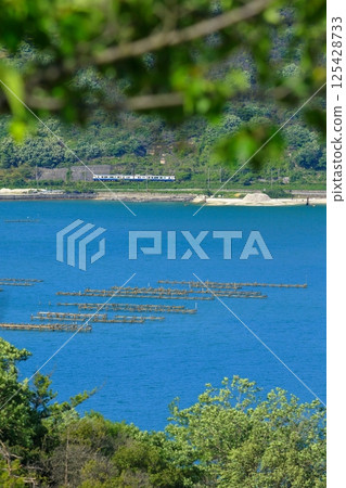 A sightseeing train that runs along the calm Seto Inland Sea A sightseeing train that runs along the calm Seto Inland Sea 125428733