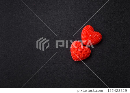 Red wax candle in the shape of a heart as decor for Valentine's Day Red wax candle in the shape of a heart as decor for Valentine's Day 125428829