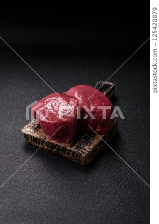 Raw beef tenderloin ribeye steak with salt and spices Raw beef tenderloin ribeye steak with salt and spices 125428879