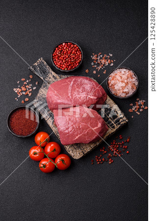 Raw beef tenderloin ribeye steak with salt and spices 125428890