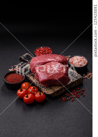 Raw beef tenderloin ribeye steak with salt and spices Raw beef tenderloin ribeye steak with salt and spices 125428891