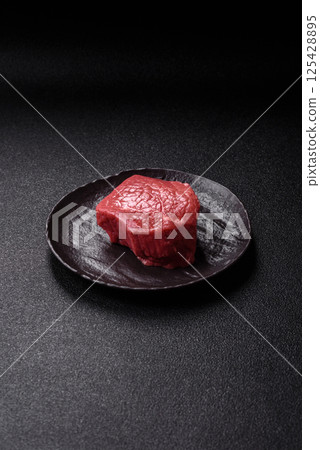 Raw beef tenderloin ribeye steak with salt and spices Raw beef tenderloin ribeye steak with salt and spices 125428895