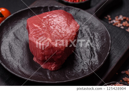 Raw beef tenderloin ribeye steak with salt and spices 125428904