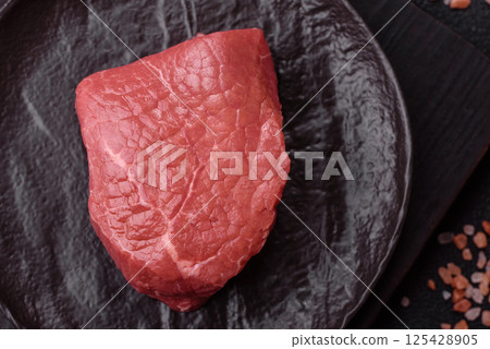 Raw beef tenderloin ribeye steak with salt and spices Raw beef tenderloin ribeye steak with salt and spices 125428905