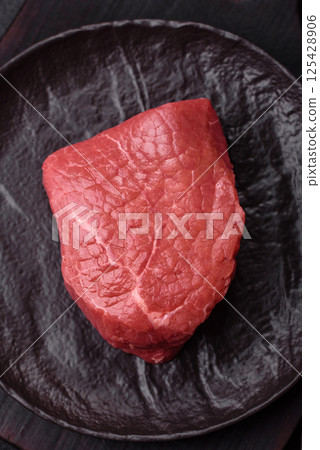 Raw beef tenderloin ribeye steak with salt and spices Raw beef tenderloin ribeye steak with salt and spices 125428906