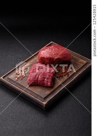 Raw beef tenderloin ribeye steak with salt and spices Raw beef tenderloin ribeye steak with salt and spices 125428915