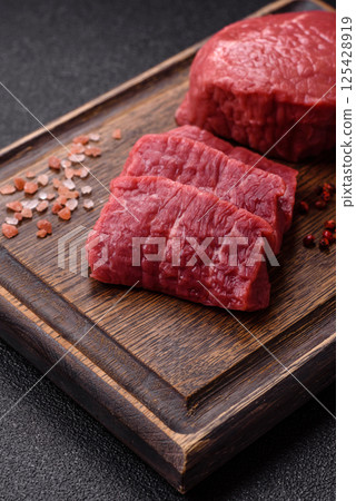 Raw beef tenderloin ribeye steak with salt and spices Raw beef tenderloin ribeye steak with salt and spices 125428919