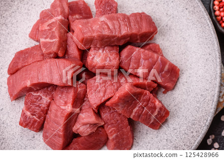 Raw beef tenderloin cut into slices with salt and spices Raw beef tenderloin cut into slices with salt and spices 125428966