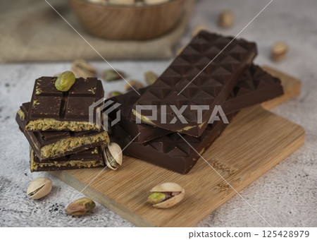 Delicious chocolate bar with pistachio pieces showcased in a Dubai setting, perfect for dessert 125428979
