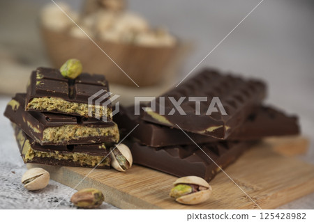 Delicious chocolate bar with pistachio pieces showcased in a Dubai setting, perfect for dessert 125428982