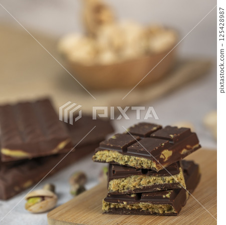 Delicious chocolate bar with pistachio pieces showcased in a Dubai setting, perfect for dessert 125428987