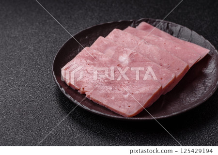 Delicious canned pink ham with salt, spices and herbs Delicious canned pink ham with salt, spices and herbs 125429194