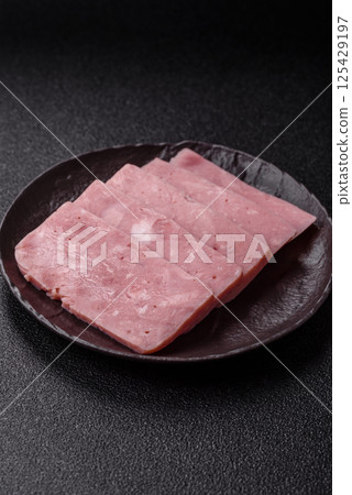 Delicious canned pink ham with salt, spices and herbs Delicious canned pink ham with salt, spices and herbs 125429197