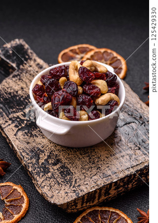 Mixture of roasted cashews and dried cranberries Mixture of roasted cashews and dried cranberries 125429330
