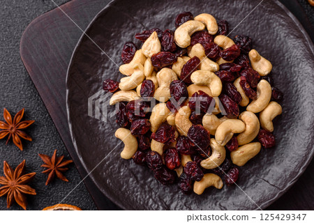 Mixture of roasted cashews and dried cranberries Mixture of roasted cashews and dried cranberries 125429347