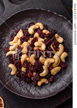 Mixture of roasted cashews and dried cranberries Mixture of roasted cashews and dried cranberries 125429348