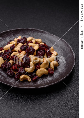 Mixture of roasted cashews and dried cranberries Mixture of roasted cashews and dried cranberries 125429353