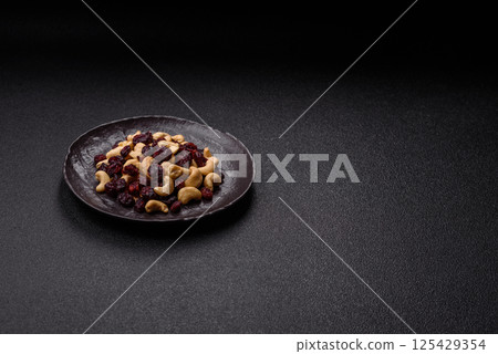 Mixture of roasted cashews and dried cranberries Mixture of roasted cashews and dried cranberries 125429354