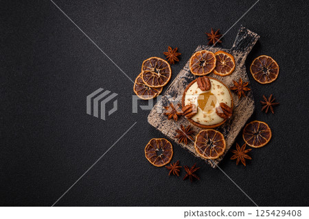 Sweet round tart with white citrus cream and pecans Sweet round tart with white citrus cream and pecans 125429408