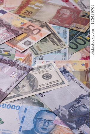 A background consisting of paper banknotes of different currencies 125429705
