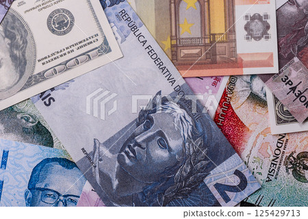 A background consisting of paper banknotes of different currencies 125429713