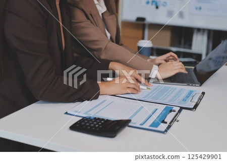 Accounting company provide finance and taxation planning for profitable cash flow, Auditor and accountant team working in office, analyze financial data and accounting record with calculator.Insight Accounting company provide finance and taxation planning for profitable cash flow, Auditor and accountant team working in office, analyze financial data and accounting record with calculator.Insight 125429901