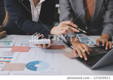 Accounting company provide finance and taxation planning for profitable cash flow, Auditor and accountant team working in office, analyze financial data and accounting record with calculator.Insight Accounting company provide finance and taxation planning for profitable cash flow, Auditor and accountant team working in office, analyze financial data and accounting record with calculator.Insight 125429911