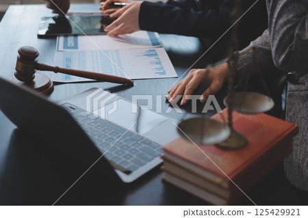 Judge gavel with Justice lawyers having team meeting at law firm background. Concepts of Law and Legal services. 125429921