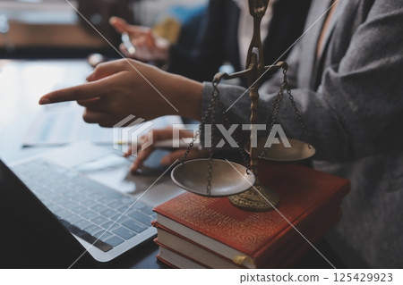 Judge gavel with Justice lawyers having team meeting at law firm background. Concepts of Law and Legal services. Judge gavel with Justice lawyers having team meeting at law firm background. Concepts of Law and Legal services. 125429923