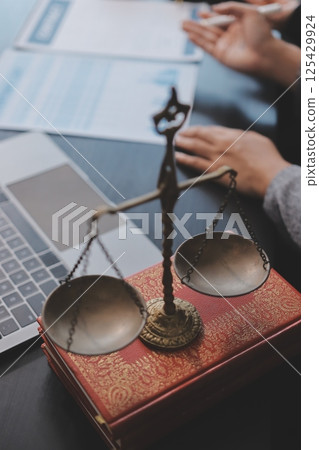 Judge gavel with Justice lawyers having team meeting at law firm background. Concepts of Law and Legal services. 125429924