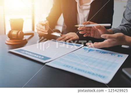 Judge gavel with Justice lawyers having team meeting at law firm background. Concepts of Law and Legal services. 125429925