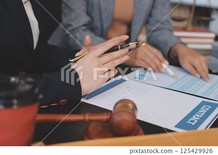 Judge gavel with Justice lawyers having team meeting at law firm background. Concepts of Law and Legal services. 125429926