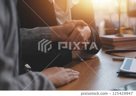 Judge gavel with Justice lawyers having team meeting at law firm background. Concepts of Law and Legal services. Judge gavel with Justice lawyers having team meeting at law firm background. Concepts of Law and Legal services. 125429947