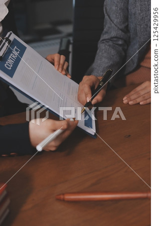 Judge gavel with Justice lawyers having team meeting at law firm background. Concepts of Law and Legal services. Judge gavel with Justice lawyers having team meeting at law firm background. Concepts of Law and Legal services. 125429956