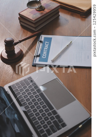 Judge gavel with Justice lawyers having team meeting at law firm background. Concepts of Law and Legal services. 125429959