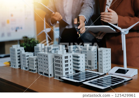 Discussion among businesspeople on the latest developments in solar cell panel technology and Solar Energy Environment city Concept. 125429961