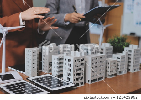 Discussion among businesspeople on the latest developments in solar cell panel technology and Solar Energy Environment city Concept. 125429962
