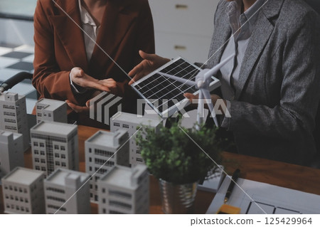 Discussion among businesspeople on the latest developments in solar cell panel technology and Solar Energy Environment city Concept. Discussion among businesspeople on the latest developments in solar cell panel technology and Solar Energy Environment city Concept. 125429964