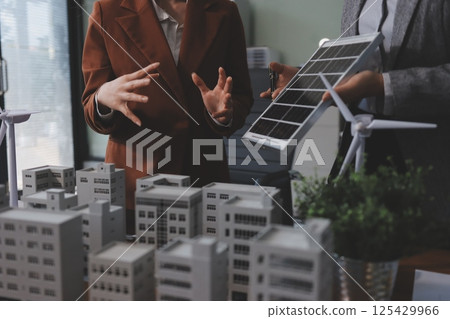 Discussion among businesspeople on the latest developments in solar cell panel technology and Solar Energy Environment city Concept. 125429966