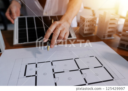 Discussion among businesspeople on the latest developments in solar cell panel technology and Solar Energy Environment city Concept. 125429997