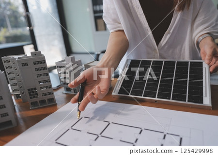 Discussion among businesspeople on the latest developments in solar cell panel technology and Solar Energy Environment city Concept. 125429998