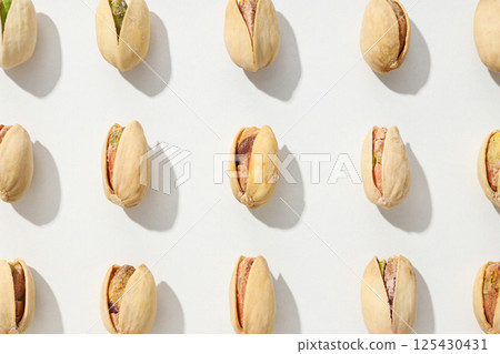 Pistachios in the shell, on a light background. Pistachios in the shell, on a light background. 125430431